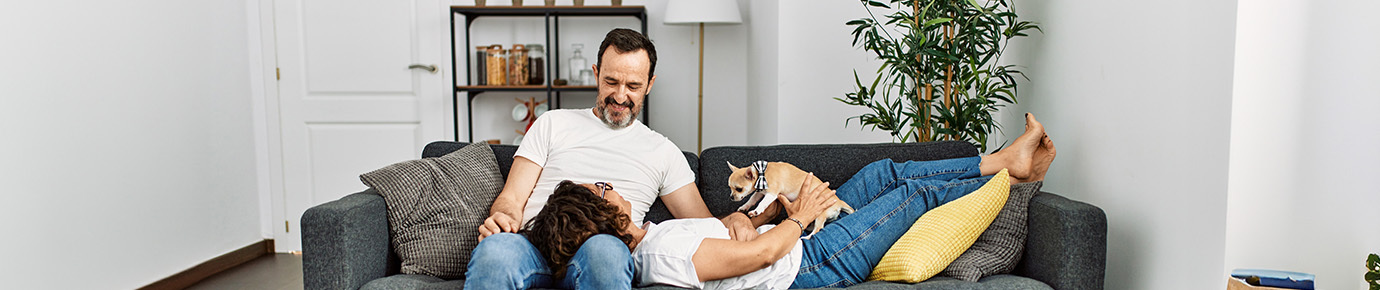 Couple on couch together with their dog