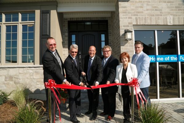 Ribbon cutting ceremony for London's first net-zero home, featuring members of the Sifton team, cutting the ribbon